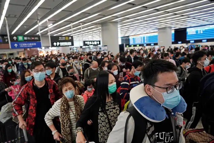 Passengers wear protective face masks at the departure hall of a high speed train station in Hong Kong.